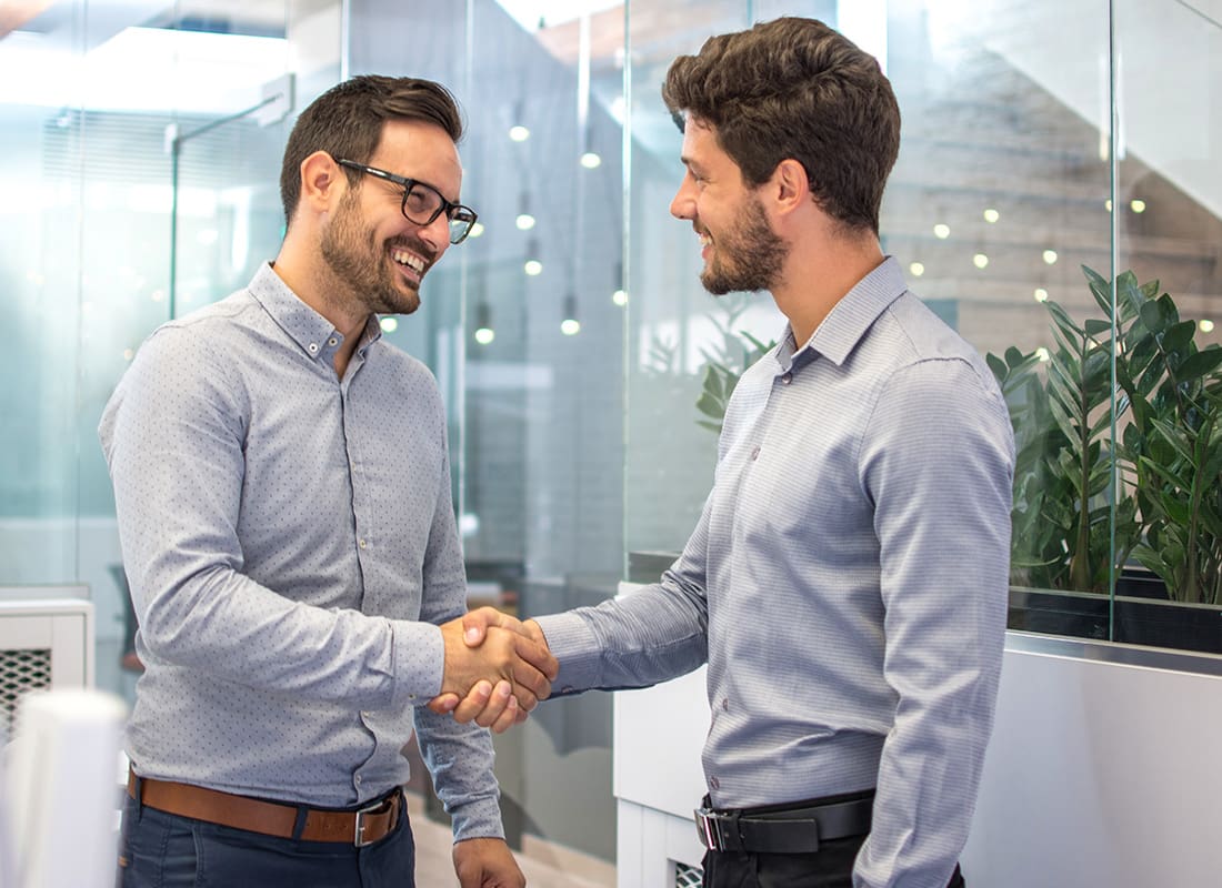 About Our Agency - Two Business People Shaking Hands in an Office